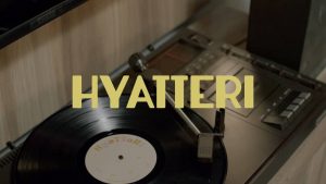 A vintage vinyl record playing and the cover art of the song Hyatteri by Sajjan Raj Vaidya
